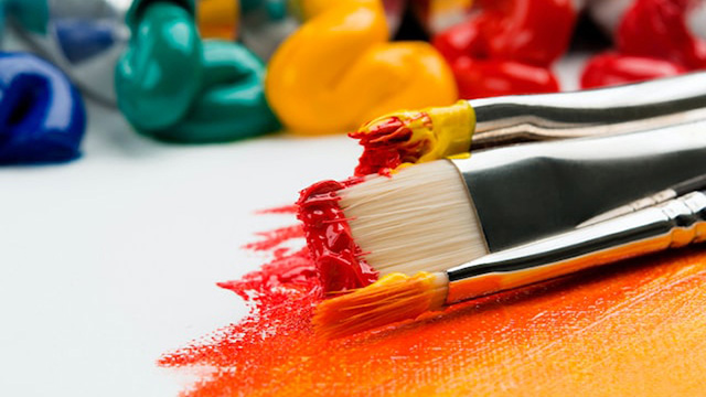 Paint brushes with red and yellow paints